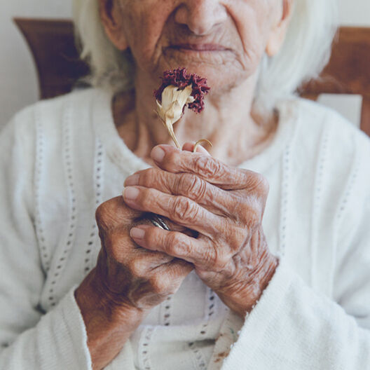Older Woman Holding Flower